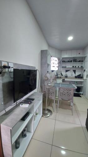 a kitchen with a table and a dining room at Flats Atitude Maragogi centro in Maragogi