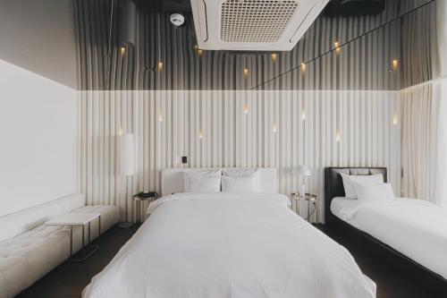Postel nebo postele na pokoji v ubytování ACC Design Hotel