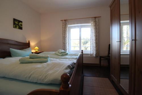 a bedroom with a large bed and a window at Gutshof Dubnitz Gutshof Dubnitz -Ferienwohnung 5 " Dörthe " in Dubnitz