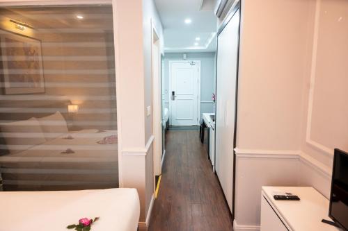 a small room with a bed and a hallway at Thiên Ân Hotel Bắc Giang in Bắc Giang