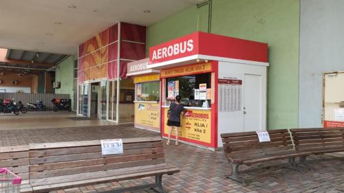a store with two benches in front of it at Bdr Bukit Tinggi Klang Tropicana Garden Homestay in Klang