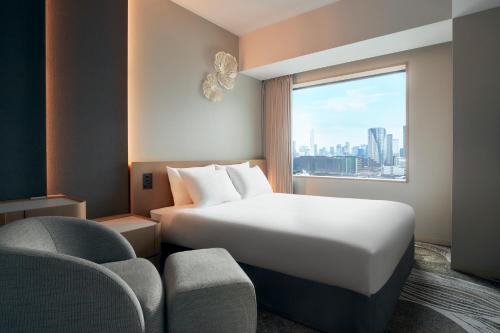 a hotel room with a bed and a window at Hotel JAL City Tokyo Toyosu in Tokyo