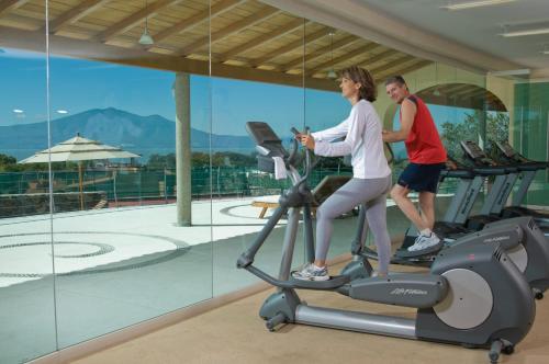 a man and a woman on a treadmill in a gym at El Dorado Ajijic by Restavio in Ajijic
