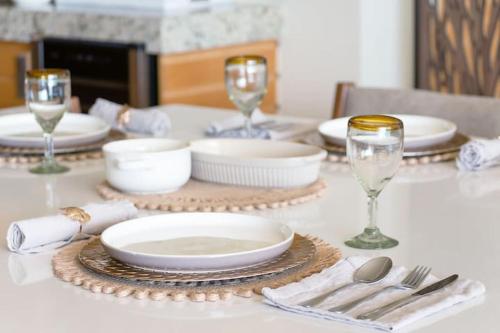 a table with plates and glasses on a table at El Dorado Ajijic by Restavio in Ajijic