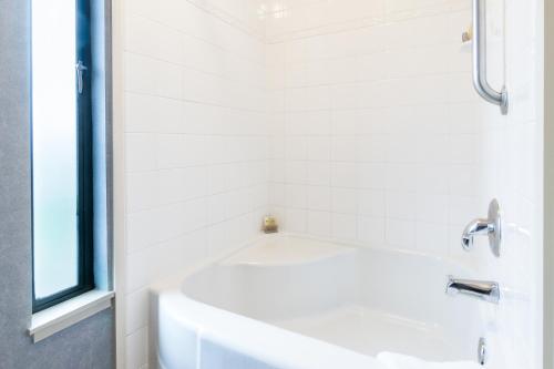 a white bath tub in a bathroom with a window at Silverado Resort and Spa 221 in Napa