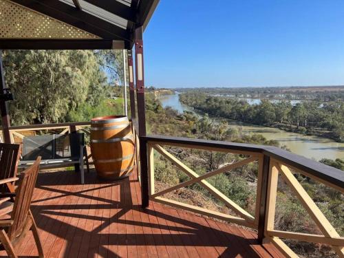 a balcony with a view of a river and a barrel at Riverview BnB in Waikerie