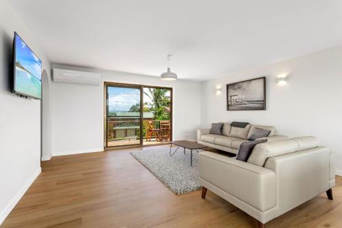 a living room with a couch and a table at 86 Becker Road in Forster