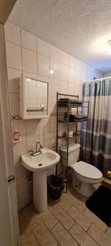 a bathroom with a sink and a toilet at GATED AND SECURED APPARTMENT 6 MINS FROM THE BEACH in Puerto Peñasco