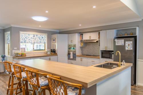 a kitchen with a large island with wooden counter tops at Fair Views in Sussex inlet