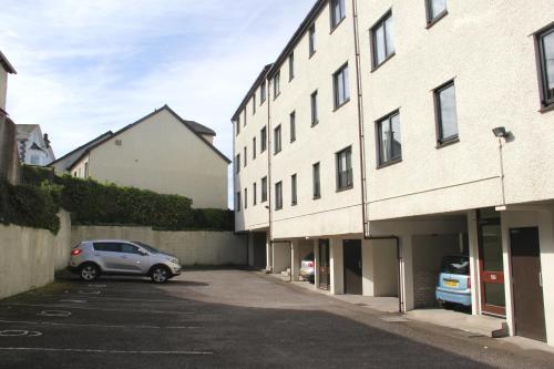 a car parked in a parking lot next to a building at Howgill in Windermere