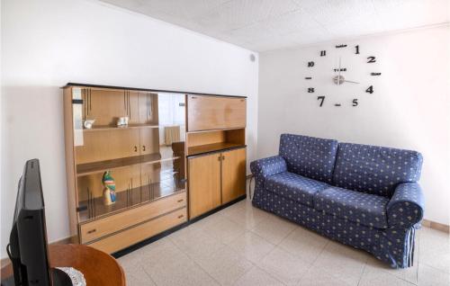 a living room with a couch and a clock on the wall at 3 Bedroom Stunning Home In Ventimiglia in Ventimiglia