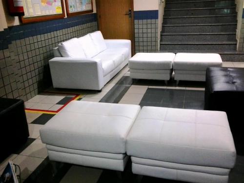 a group of white couches in a room at Inácio Palace Hotel in Rio Branco