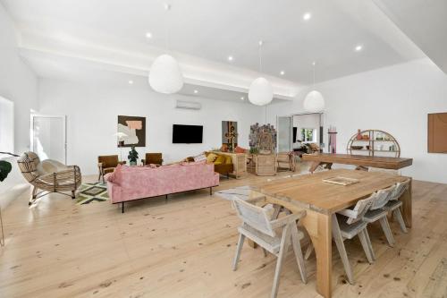 a living room with a table and a couch at The Pink Lodge in Lorne