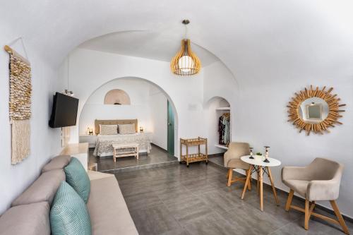 a living room with a couch and a bed at Villa Thiranthemis in Fira