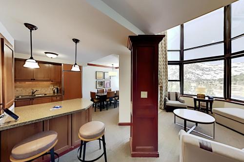 a kitchen and living room with a counter and a table at Resort at Squaw Creek's 810 & 812 in Olympic Valley