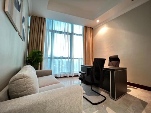 a living room with a couch and a television at Fairview Luxury Apartments in Dar es Salaam