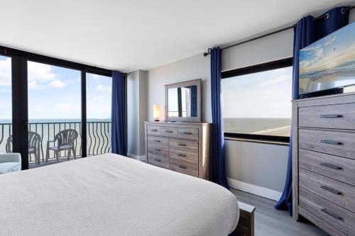 a bedroom with a bed and a large window at Oceanfront Penthouse, Two-Story, 3 Bedrooms in Myrtle Beach