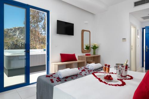 a bedroom with a bed with red flowers on it at Eagles Nest in Pefki