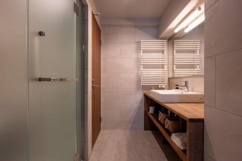 a bathroom with a sink and a mirror at Kawamotoya in Nozawa Onsen