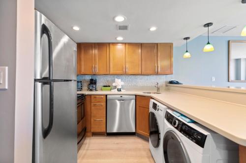 a kitchen with a stainless steel refrigerator and a dishwasher at Hosteeva 17th Floor Palms Resort Penthouse Oceanfront w Balcony in Myrtle Beach