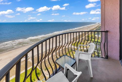 a balcony with two chairs and the ocean at Hosteeva 17th Floor Palms Resort Penthouse Oceanfront w Balcony in Myrtle Beach