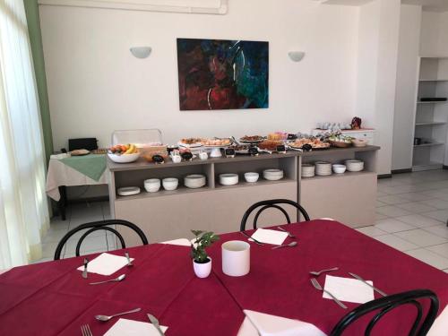 a dining room with a table with a red table cloth at HOTEL FLYING in Pesaro