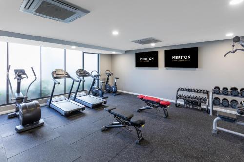 a gym with treadmills and machines in a room at Meriton Suites Coward Street, Mascot in Sydney