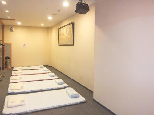 Ένα ή περισσότερα κρεβάτια σε δωμάτιο στο Natural Onsen Hostel Hidamari no Yu