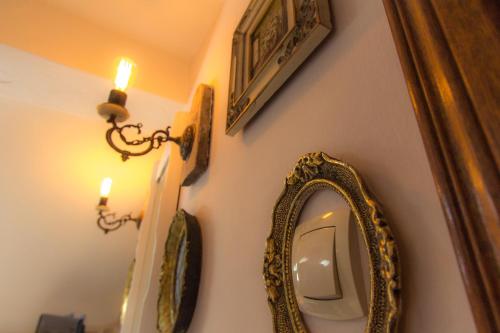 a bathroom with a mirror and a candle on a wall at Palazzo Drusko Deluxe Rooms in Kotor
