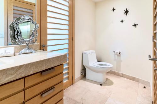 a bathroom with a toilet and a mirror at El Dorado Ajijic by Restavio in Ajijic