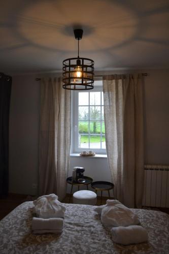 a bedroom with a bed and a window at La métairie du rumain in Hengoat