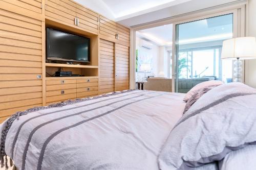 a bedroom with a bed with a tv on a wooden wall at El Dorado Ajijic by Restavio in Ajijic