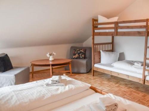 a room with two bunk beds and a table at Gasthaus Jägerhaus in Fridingen an der Donau
