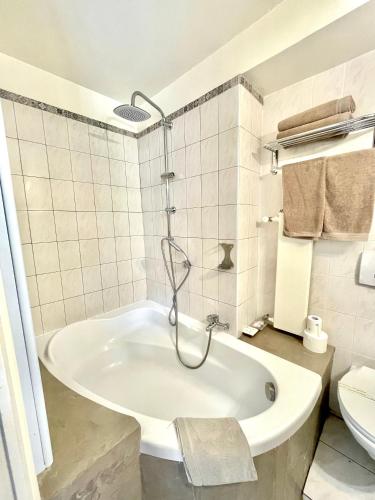 a bathroom with a tub and a toilet at Le Mirval in La Brigue