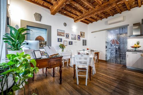 a kitchen and dining room with a desk and a table at La Stella d'Oro B&B in Florence