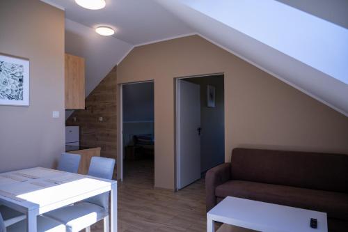 a living room with a couch and a table at Camping Bartbo in Olsztyn