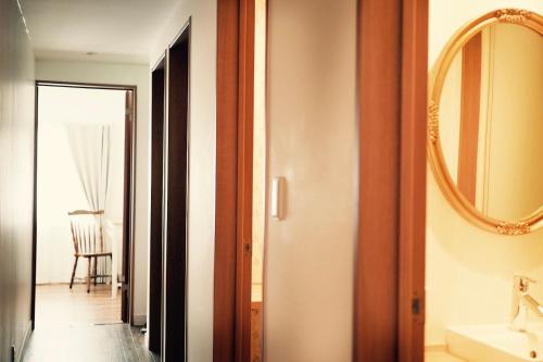 a bathroom with a sink and a mirror at L'AtelieR Guest House Yonago in Yonago