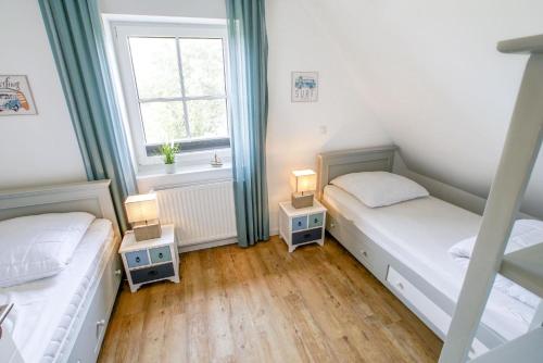 Ένα ή περισσότερα κρεβάτια σε δωμάτιο στο Ferienhaus 15 "Gut Tossens"
