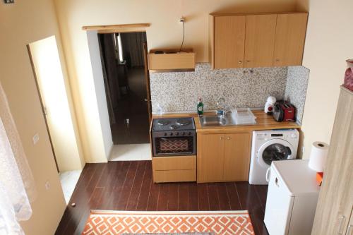 a small kitchen with a stove and a sink at Main square apartment in Symi