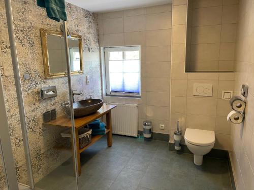 a bathroom with a sink and a toilet at Fenix Hall Boutique Hotel Hallstatt in Hallstatt