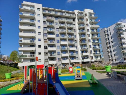 a playground in front of a apartment building at Apartamenty na Morenie in Gdańsk