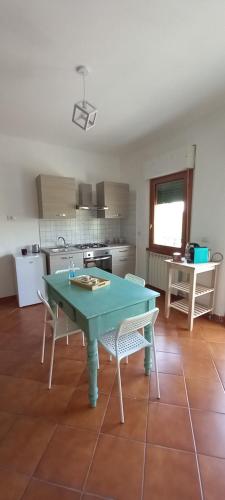 een keuken met een groene tafel en stoelen. bij EasyHouse in Fiuggi
