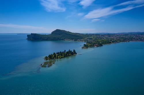 an island in the middle of a large body of water at AHG Donna Silvia Wellness Hotel in Manerba del Garda