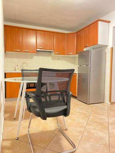 a kitchen with a table and a chair and a refrigerator at Piazza in Dubrovnik