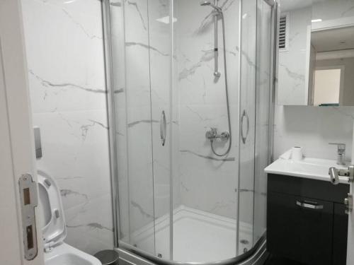a bathroom with a shower and a sink at Şişli Apartment, 2 bedrooms, 250 m metro, New Modern Residence in Istanbul
