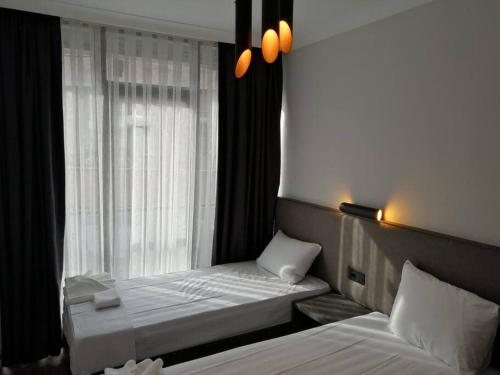 a bedroom with two beds and a window at Şişli Apartment, 2 bedrooms, 250 m metro, New Modern Residence in Istanbul