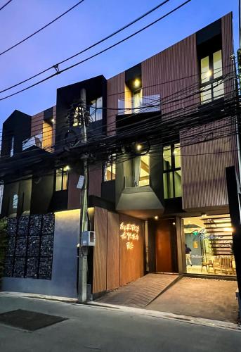 a building with a large building with a balcony at The Nhorm Hotel Ratchada in Bangkok