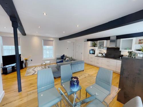 a living room with a couch and a table and chairs at 73A Weavers House - Mountergate in Norwich