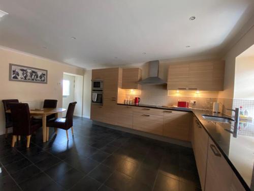 a kitchen with a table and a dining room at The Roundal in Crail