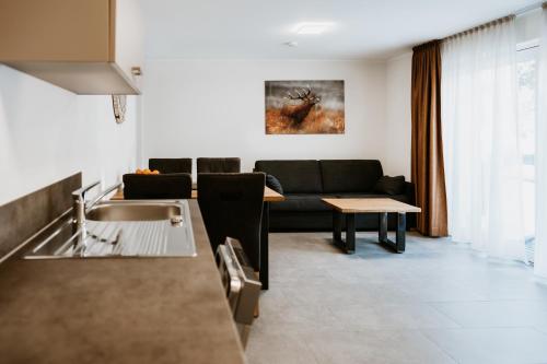 a living room with a couch and a table at My Lodge Winterberg in Winterberg